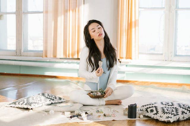 Photo by Mikhail Nilov: https://www.pexels.com/photo/serene-asian-woman-meditating-with-sage-smudge-stick-6945068/